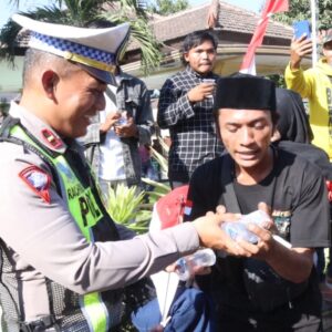 *Humanis Polisi Berbagi Air Mineral Untuk Peserta Unras di Situbondo*