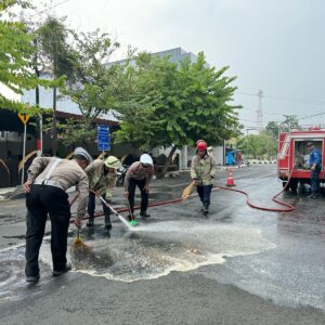 *Sigap, Polisi bersama Damkar Bersihkan Tumpahan Solar di Jalan Raya Lamongan Antisipasi Kecelakaan*